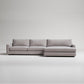 Modern gray L-shaped sectional sofa with textured fabric upholstery on white background, minimalist design
