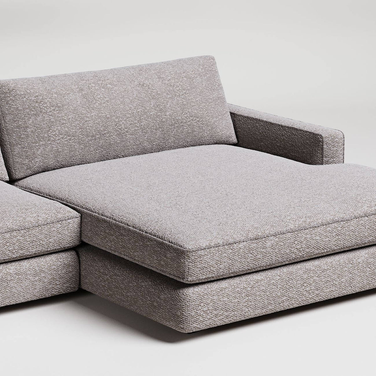 Modern gray L-shaped sectional sofa with wide chaise lounge, textured fabric upholstery, clean minimal design
